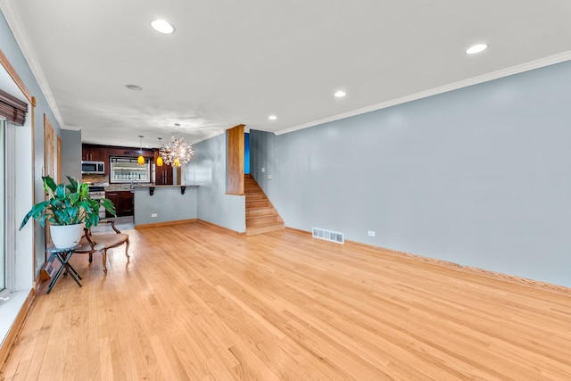 7446 Lake St, Morton Grove, IL 60053 - empty room with ornamental molding, stairs, recessed lighting, light wood-style floors, and a chandelier