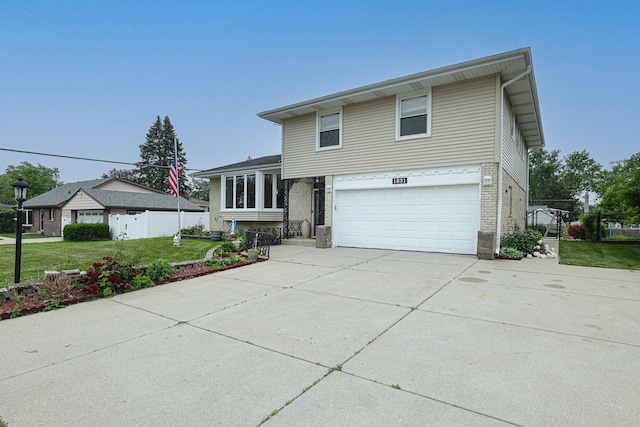 1831 E Camp Mcdonald Rd Unit 0, Mount Prospect, IL 60056 - split level home with brick siding, a garage, and concrete driveway
