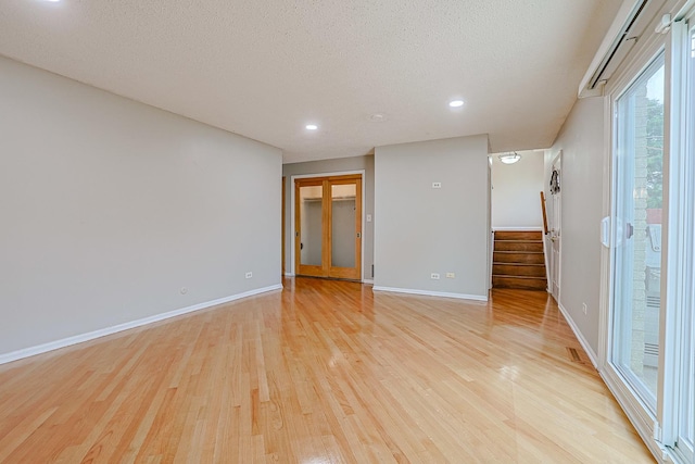 1831 E Camp Mcdonald Rd Unit 0, Mount Prospect, IL 60056 - spare room featuring light wood-type flooring, stairway, a textured ceiling, and recessed lighting