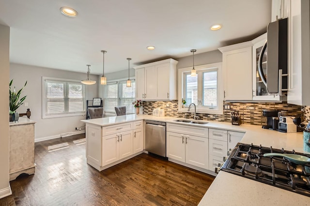 4453 N Canfield Ave, Norridge, IL 60706 - kitchen with stainless steel appliances, a peninsula, backsplash, light countertops, and recessed lighting