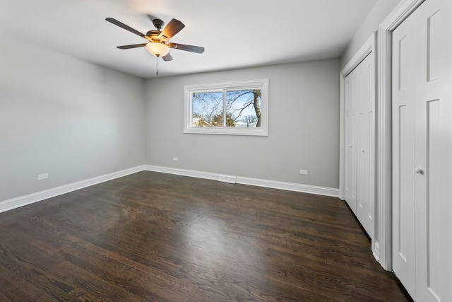 15245 Narcissus Ct, Orland Park, IL 60462 - unfurnished bedroom with dark wood finished floors, multiple closets, and a ceiling fan