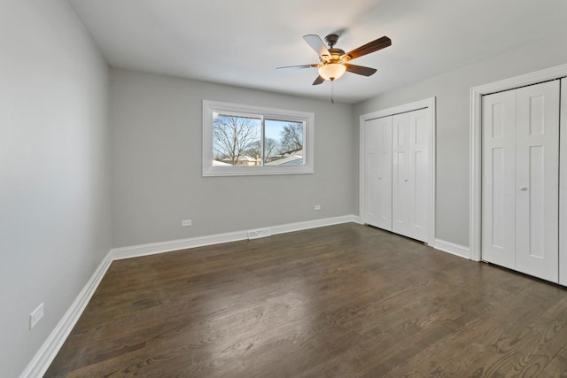 15245 Narcissus Ct, Orland Park, IL 60462 - unfurnished bedroom with two closets, dark wood finished floors, and ceiling fan