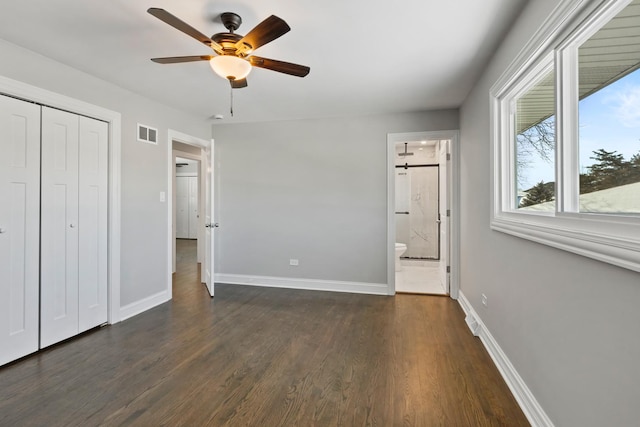 15245 Narcissus Ct, Orland Park, IL 60462 - unfurnished bedroom with dark wood-style flooring, a closet, ensuite bath, and ceiling fan