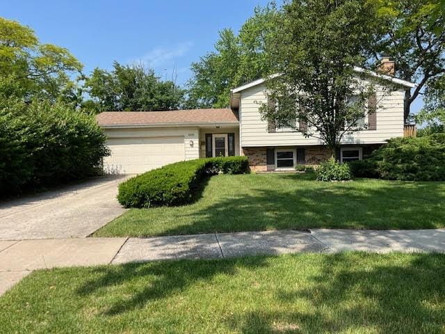 2134 S Hull Dr, Wheaton, IL 60189 - tri-level home featuring a garage, a front yard, a chimney, and concrete driveway