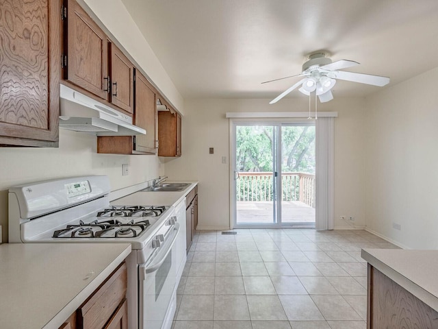 2134 S Hull Dr, Wheaton, IL 60189 - kitchen featuring white gas stove, under cabinet range hood, ceiling fan, light countertops, and brown cabinets