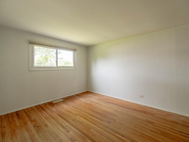 2134 S Hull Dr, Wheaton, IL 60189 - empty room featuring light wood finished floors and baseboards