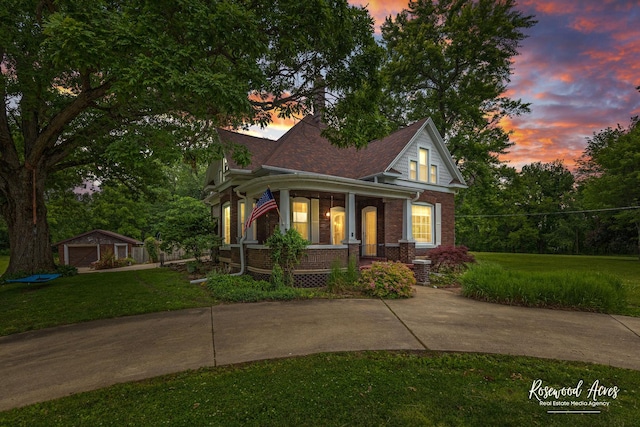 1375 E 16th Rd, Streator, IL 61364 - view of front facade featuring a porch, a front yard, brick siding, and a detached garage
