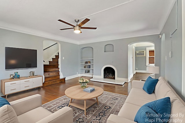 1504 W Monroe St, Waukegan, IL 60085 - living area with ceiling fan, arched walkways, built in features, dark wood-style floors, and crown molding