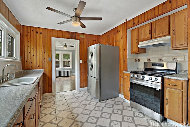 1504 W Monroe St, Waukegan, IL 60085 - kitchen with appliances with stainless steel finishes, under cabinet range hood, radiator, ceiling fan, and light flooring