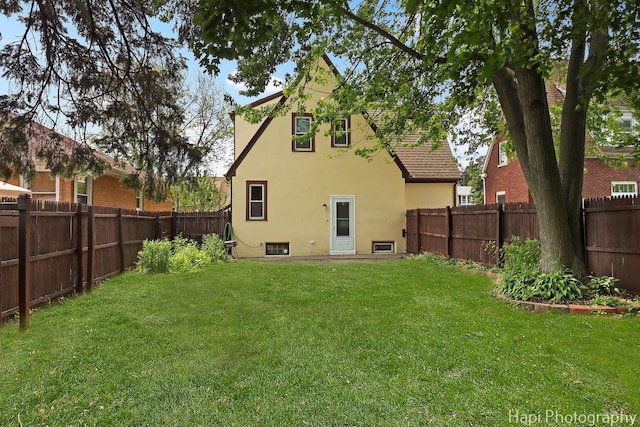 1504 W Monroe St, Waukegan, IL 60085 - rear view of property featuring stucco siding and a fenced backyard