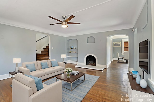 1504 W Monroe St, Waukegan, IL 60085 - living room with arched walkways, a ceiling fan, built in shelves, stairs, and a wall mounted AC