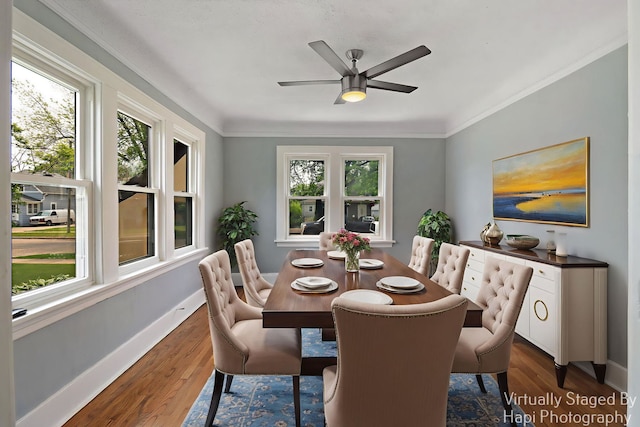 1504 W Monroe St, Waukegan, IL 60085 - dining room featuring healthy amount of natural light, dark wood-style floors, ceiling fan, and crown molding