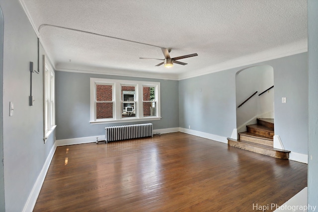 1504 W Monroe St, Waukegan, IL 60085 - spare room featuring radiator, a ceiling fan, stairs, a textured ceiling, and wood finished floors