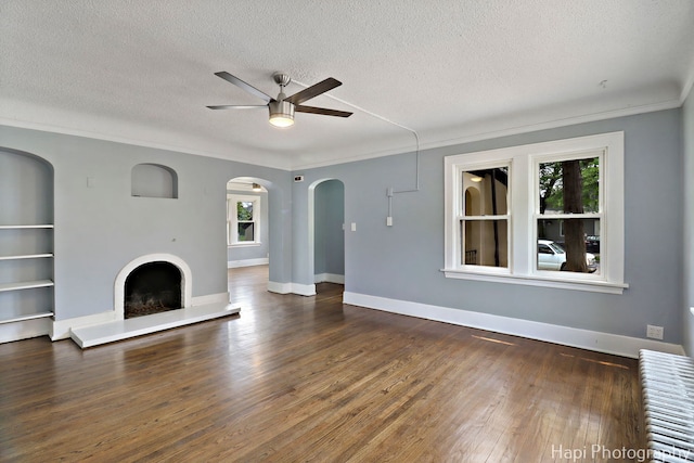 1504 W Monroe St, Waukegan, IL 60085 - unfurnished living room with ceiling fan, a textured ceiling, wood finished floors, crown molding, and a fireplace with raised hearth