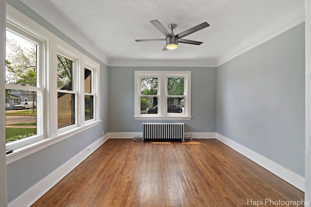 1504 W Monroe St, Waukegan, IL 60085 - unfurnished room with radiator, wood-type flooring, a textured ceiling, and ceiling fan