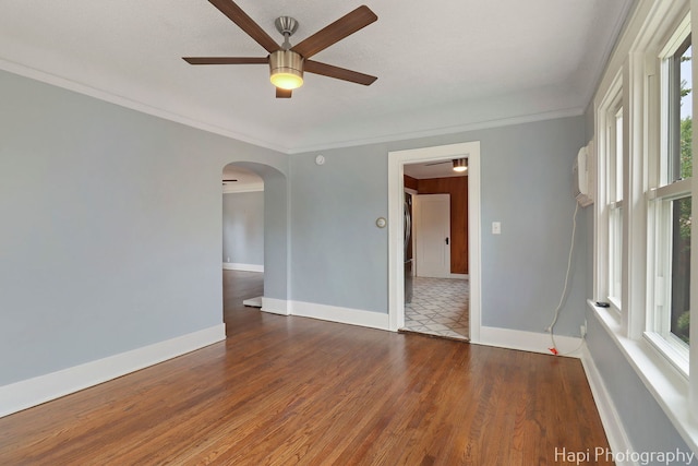 1504 W Monroe St, Waukegan, IL 60085 - empty room with arched walkways, ceiling fan, plenty of natural light, wood finished floors, and ornamental molding