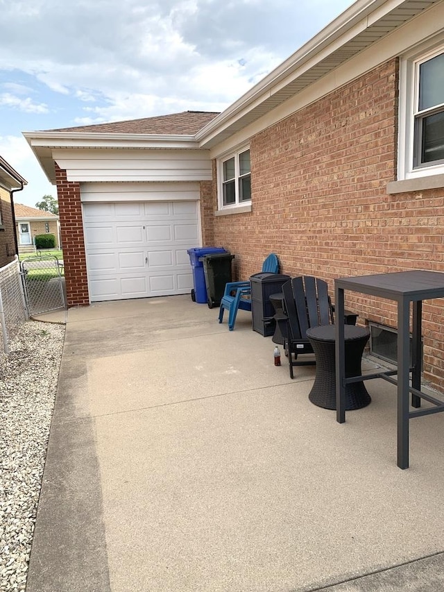 7609 W Gunnison St, Harwood Heights, IL 60706 - view of side of property with concrete driveway, brick siding, and an attached garage