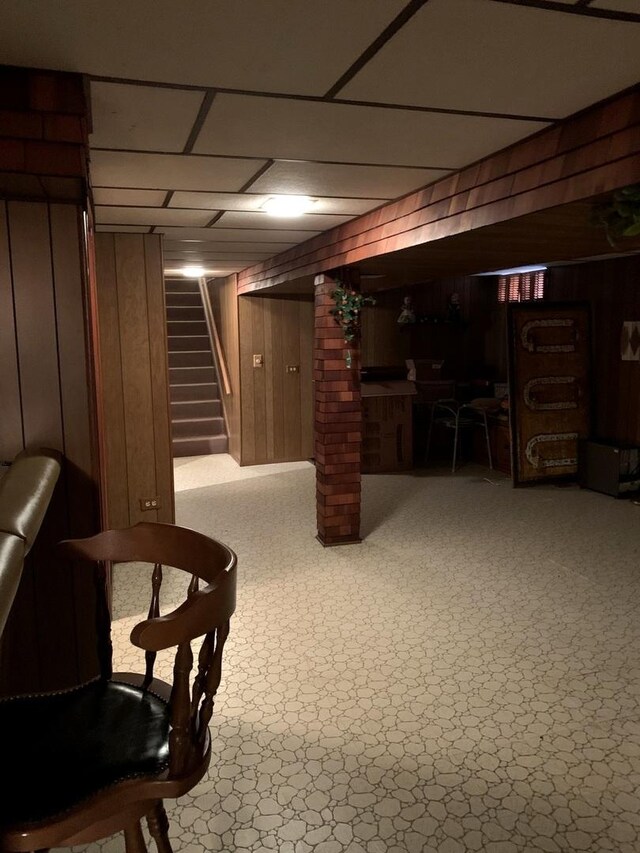 7609 W Gunnison St, Harwood Heights, IL 60706 - finished below grade area with stairway, wooden walls, and a drop ceiling
