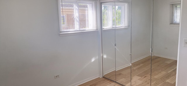 396 Thelma Ct, Wheeling, IL 60090 - unfurnished bedroom featuring light wood-type flooring and multiple windows