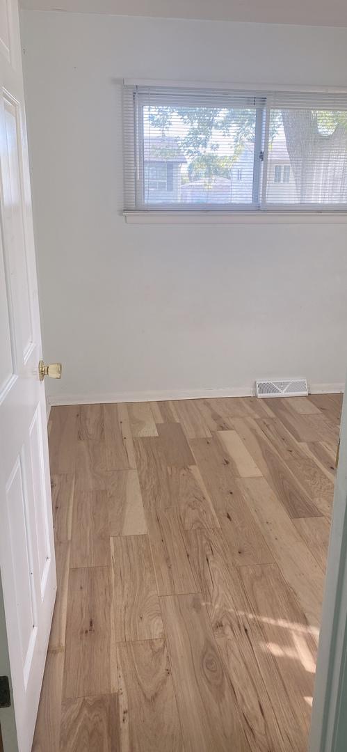 396 Thelma Ct, Wheeling, IL 60090 - spare room featuring wood finished floors and baseboards
