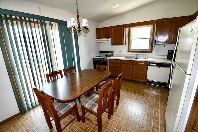 38103 N Cornell Rd, Beach Park, IL 60087 - kitchen with white appliances, under cabinet range hood, brick patterned flooring, lofted ceiling, and a chandelier