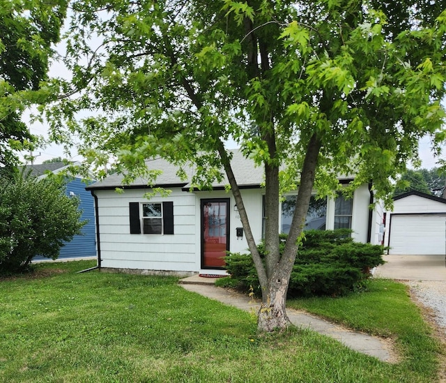 1011 E Taylor St, Dekalb, IL 60115 - view of front of house with a front lawn, an outdoor structure, driveway, and a shingled roof