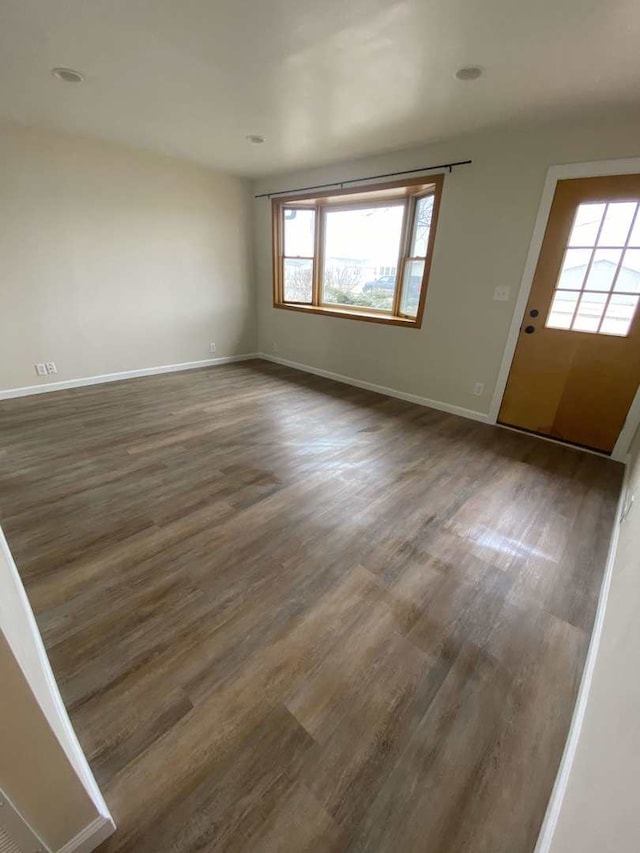 1011 E Taylor St, Dekalb, IL 60115 - unfurnished living room with plenty of natural light and wood finished floors