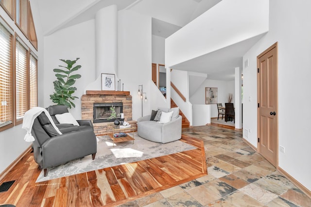 5024 Switch Grass Ln, Naperville, IL 60564 - living room with a towering ceiling, stairs, a stone fireplace, and stone finish floors
