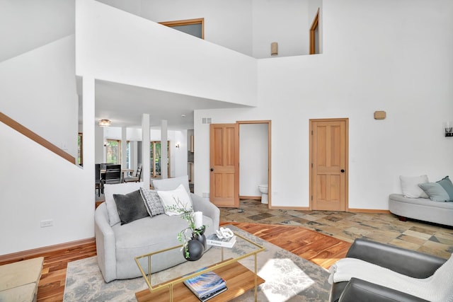 5024 Switch Grass Ln, Naperville, IL 60564 - living area featuring light wood-type flooring, a towering ceiling, and stairway