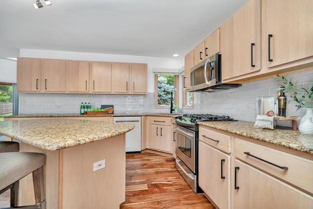 5024 Switch Grass Ln, Naperville, IL 60564 - kitchen with appliances with stainless steel finishes, light brown cabinets, light wood-type flooring, light stone counters, and recessed lighting