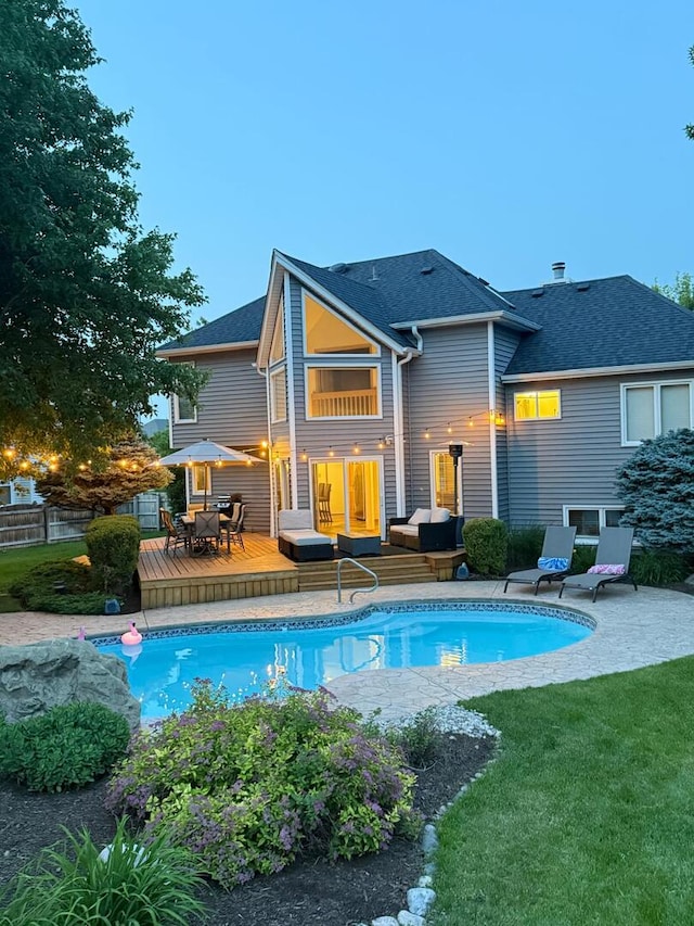 5024 Switch Grass Ln, Naperville, IL 60564 - rear view of house featuring a deck, an outdoor pool, outdoor dining space, roof with shingles, and an outdoor living space