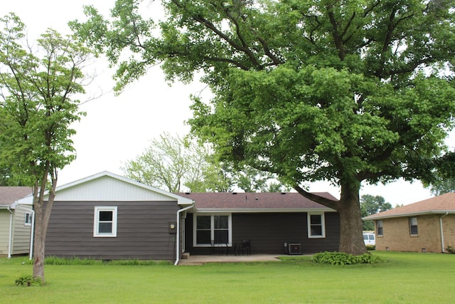 207 Cedar Dr, Clinton, IL 61727 - rear view of property with a patio and a lawn