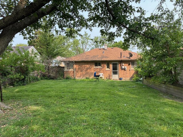 314 Meota St, Park Forest, IL 60466 - rear view of house featuring brick siding and a chimney