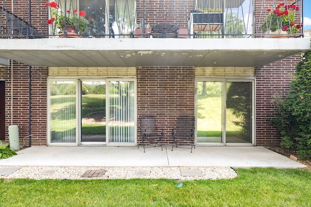 5540 Walnut Ave Unit 9A, Downers Grove, IL 60515 - rear view of property with a balcony, brick siding, and a patio