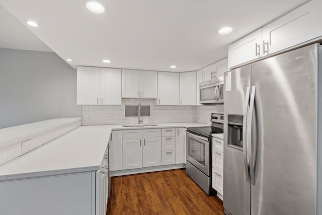 5540 Walnut Ave Unit 9A, Downers Grove, IL 60515 - kitchen featuring stainless steel appliances, white cabinets, dark wood-style floors, tasteful backsplash, and recessed lighting