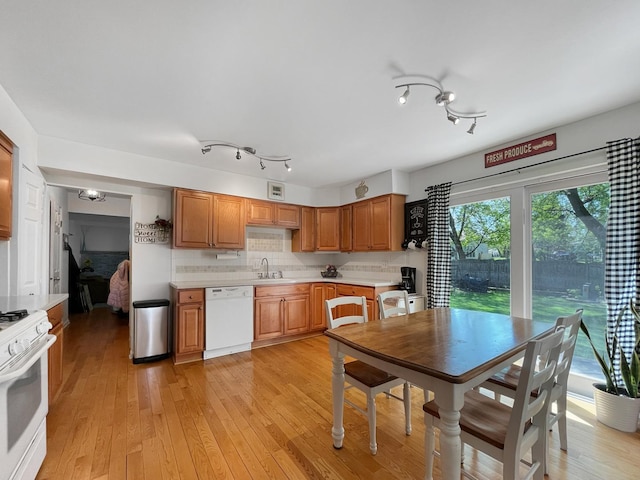 323 W Golf Rd, Libertyville, IL 60048 - kitchen featuring white appliances, light countertops, tasteful backsplash, light wood-style floors, and brown cabinetry