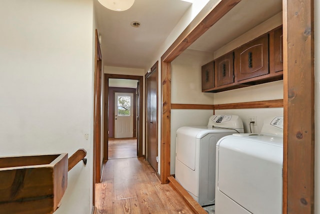 10317 195th Ave, Bristol, WI 53104 - laundry area featuring independent washer and dryer, light wood-style flooring, and cabinet space