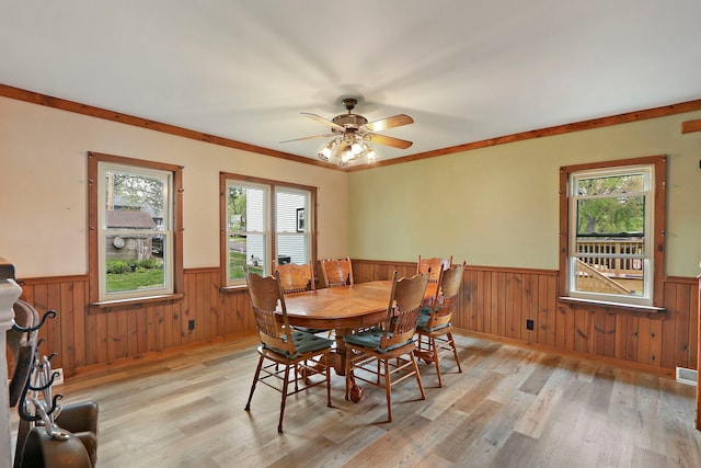10317 195th Ave, Bristol, WI 53104 - dining area featuring a wainscoted wall, light wood-type flooring, wood walls, and ceiling fan