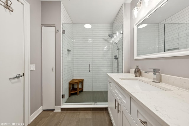 545 N Dearborn St Unit 3207, Chicago, IL 60654 - bathroom with vanity, a shower stall, and wood finished floors