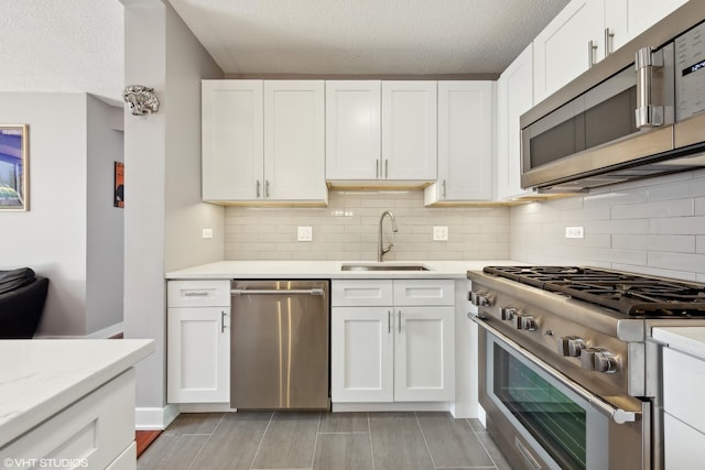 545 N Dearborn St Unit 3207, Chicago, IL 60654 - kitchen featuring stainless steel appliances, light countertops, a textured ceiling, decorative backsplash, and white cabinets