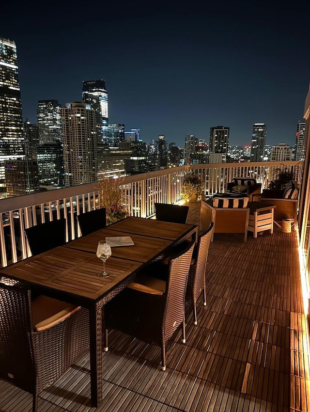 545 N Dearborn St Unit 3207, Chicago, IL 60654 - deck at twilight featuring outdoor dining space and a view of city lights