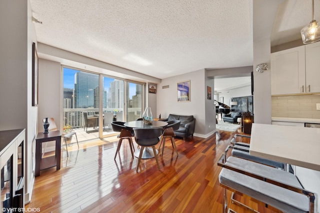 545 N Dearborn St Unit 3207, Chicago, IL 60654 - dining area featuring a textured ceiling and light wood-type flooring