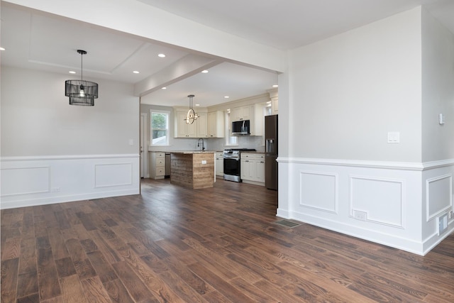 126 E Ave, La Grange, IL 60525 - kitchen featuring stainless steel gas stove, fridge with ice dispenser, dark wood-style flooring, a center island, and recessed lighting