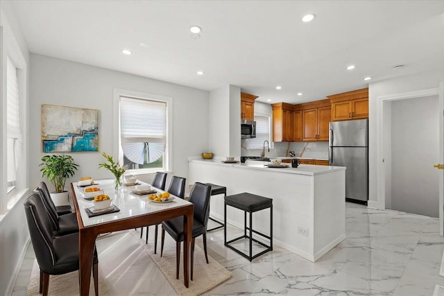 11456 S Talman Ave, Chicago, IL 60655 - kitchen with stainless steel appliances, recessed lighting, brown cabinetry, light countertops, and a peninsula