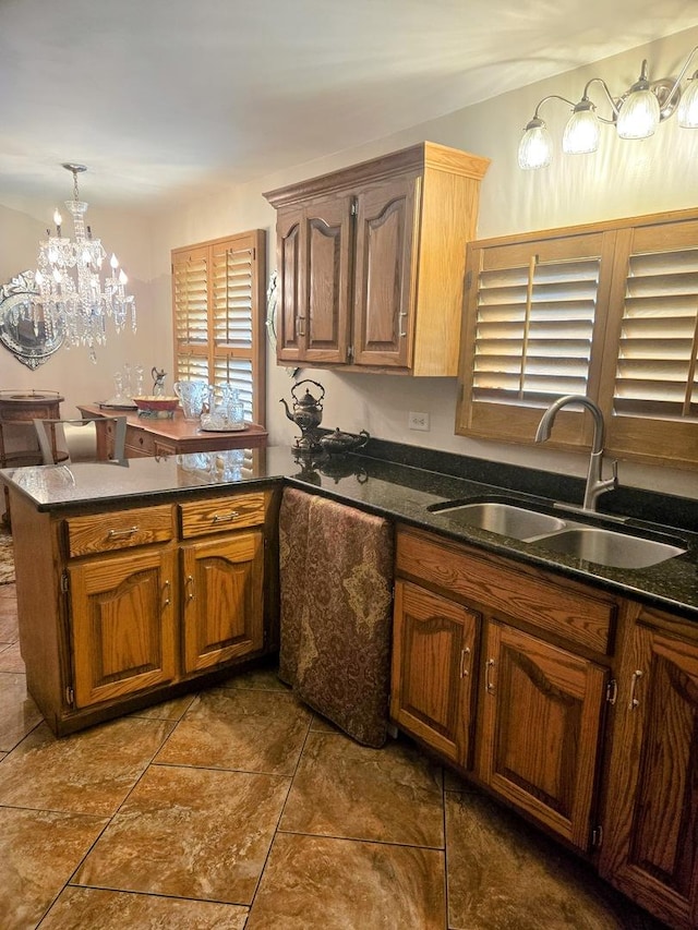 842 Highview Ave, Olympia Fields, IL 60461 - kitchen with a peninsula, dark tile patterned floors, a chandelier, and dark stone countertops