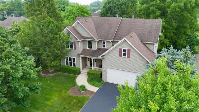 1103 Paul Ct, Fox River Grove, IL 60021 - traditional home featuring covered porch, a front lawn, a garage, driveway, and a shingled roof