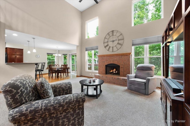 1103 Paul Ct, Fox River Grove, IL 60021 - living room featuring healthy amount of natural light, a high ceiling, light carpet, and a brick fireplace