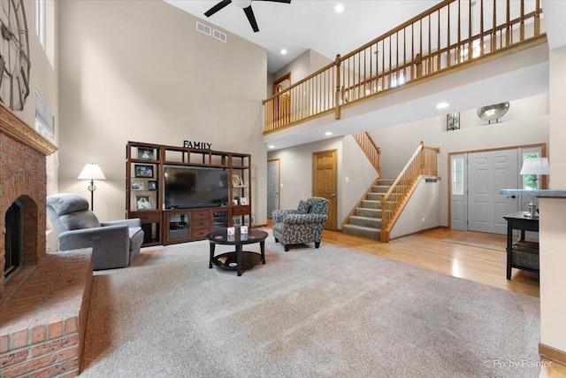 1103 Paul Ct, Fox River Grove, IL 60021 - living area with a high ceiling, ceiling fan, stairway, wood finished floors, and a brick fireplace
