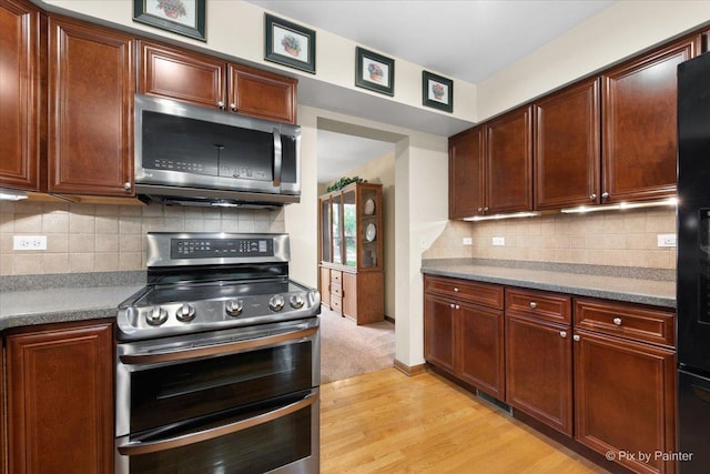 1103 Paul Ct, Fox River Grove, IL 60021 - kitchen featuring appliances with stainless steel finishes, light wood-style floors, and tasteful backsplash