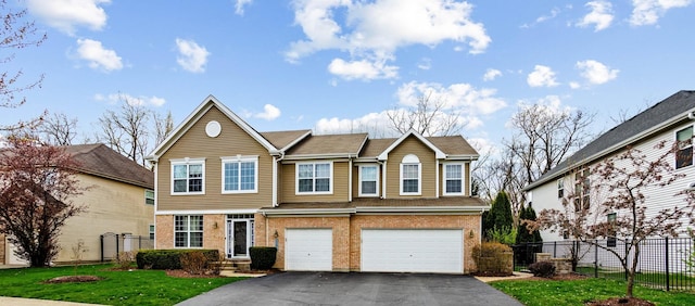 184 Primrose Ln, Bartlett, IL 60103 - view of front of house with driveway, brick siding, and an attached garage